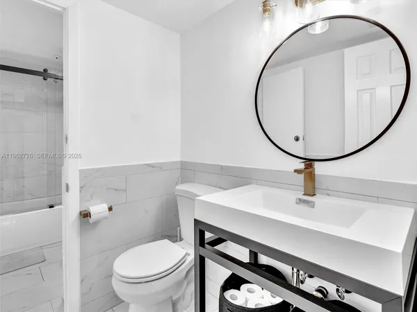 a bathroom with a sink a mirror and a toilet