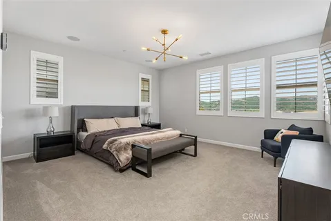 a spacious bedroom with a bed and a couch