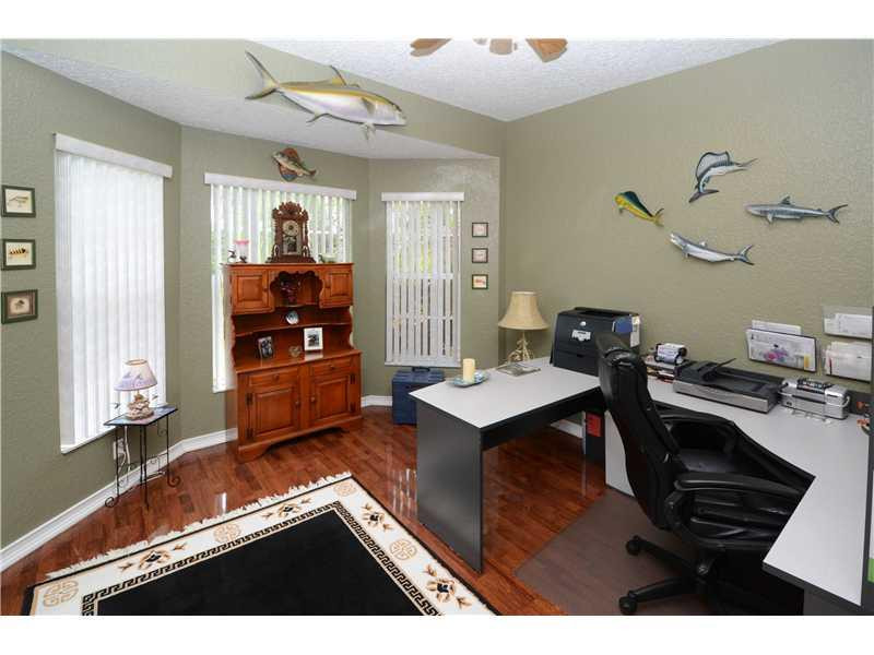 18951 Southwest 51st Manor Southwest Ranches, FL 33332 - Photo 15 of 27 a living room with a table chairs and a wooden floor