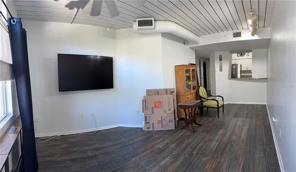 a view of a room with wooden floor and furniture