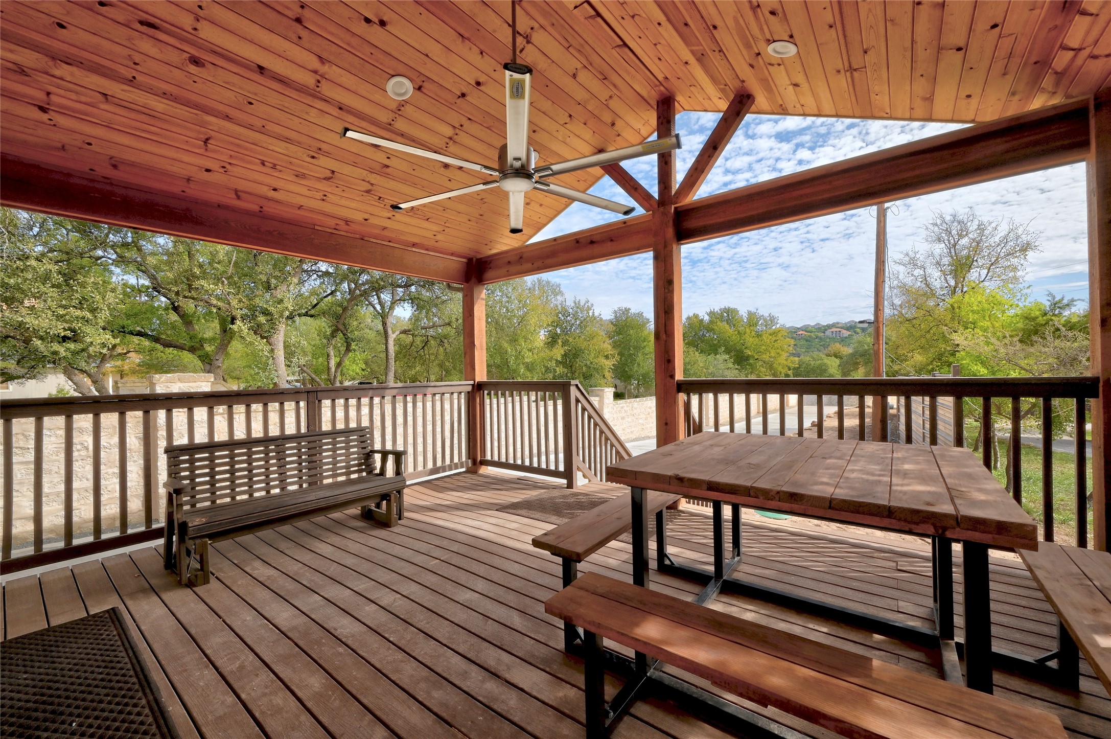 2903 Oak Ridge Drive Spicewood, TX 78669 - Photo 14 of 33 Main House Covered Porch featuring a ceiling fan and outdoor dining area