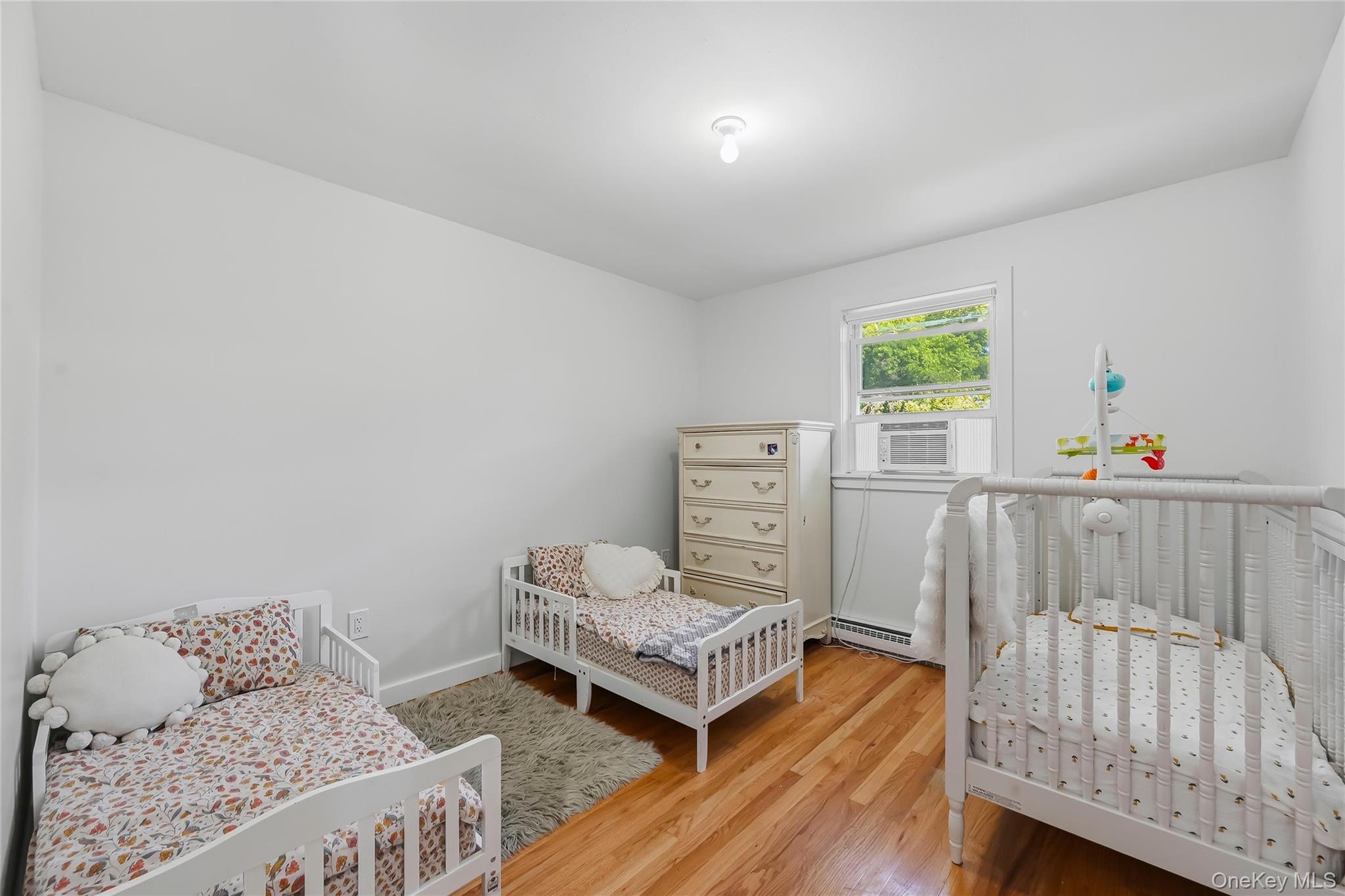 249 Ridge Road Highland Mills, NY 10930 - Photo 20 of 38 Light-filled interior space featuring wood-finish flooring, a single window, and a ceiling-mounted light fixture
