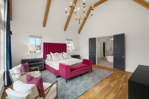 a bedroom with a bed and a window with couch