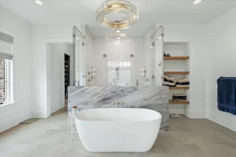 a kitchen with stainless steel appliances granite countertop a stove and white cabinets with wooden floor