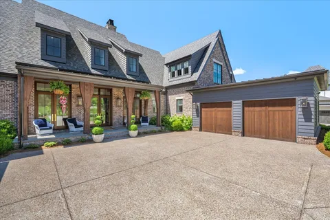 a front view of a house with a yard table and chairs