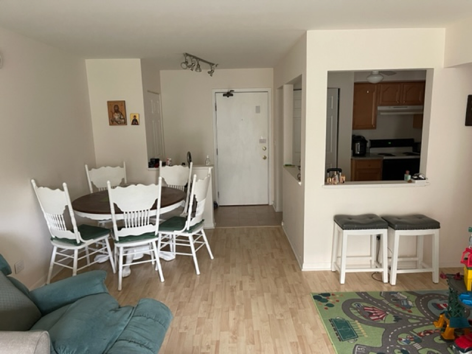 2226 South Goebbert Road, Unit 270 Arlington Heights, IL 60005 - Photo 5 of 19 a dining room with furniture and wooden floor