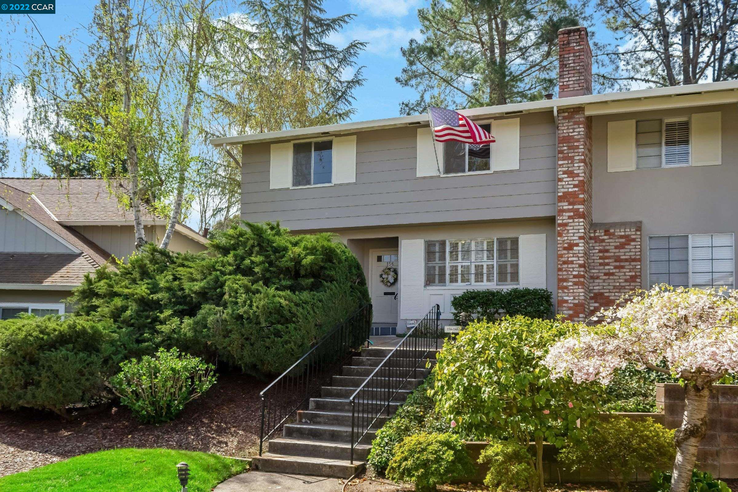a front view of a house with garden