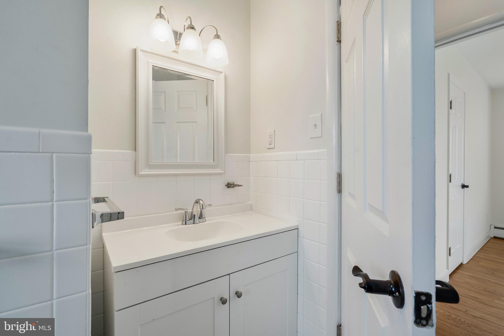 404 West Pearl Street Rising Sun, MD 21911 - Photo 11 of 23 a bathroom with a sink and a mirror