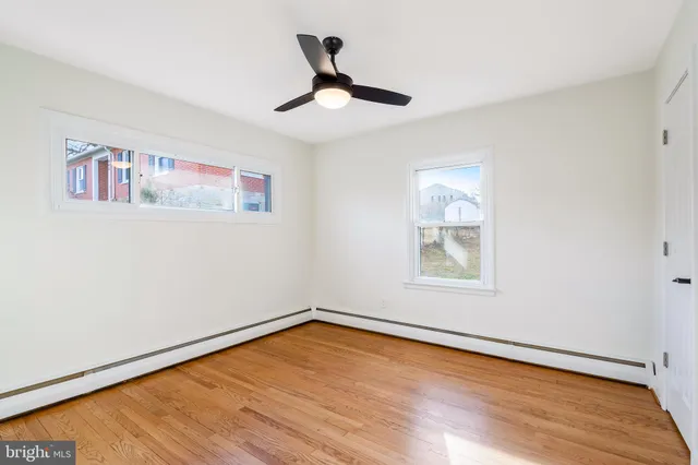 a view of empty room with wooden floor