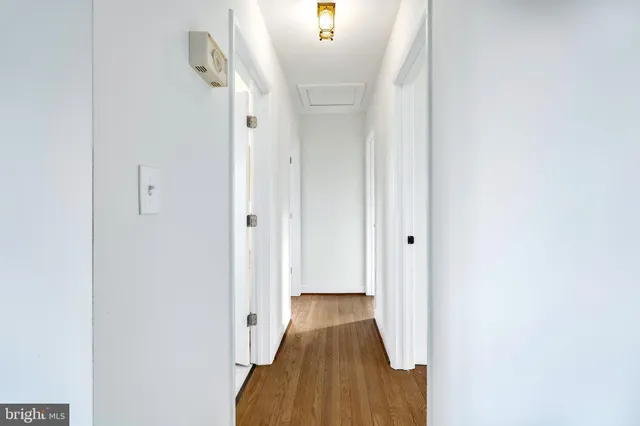 a view of a hallway with wooden floor