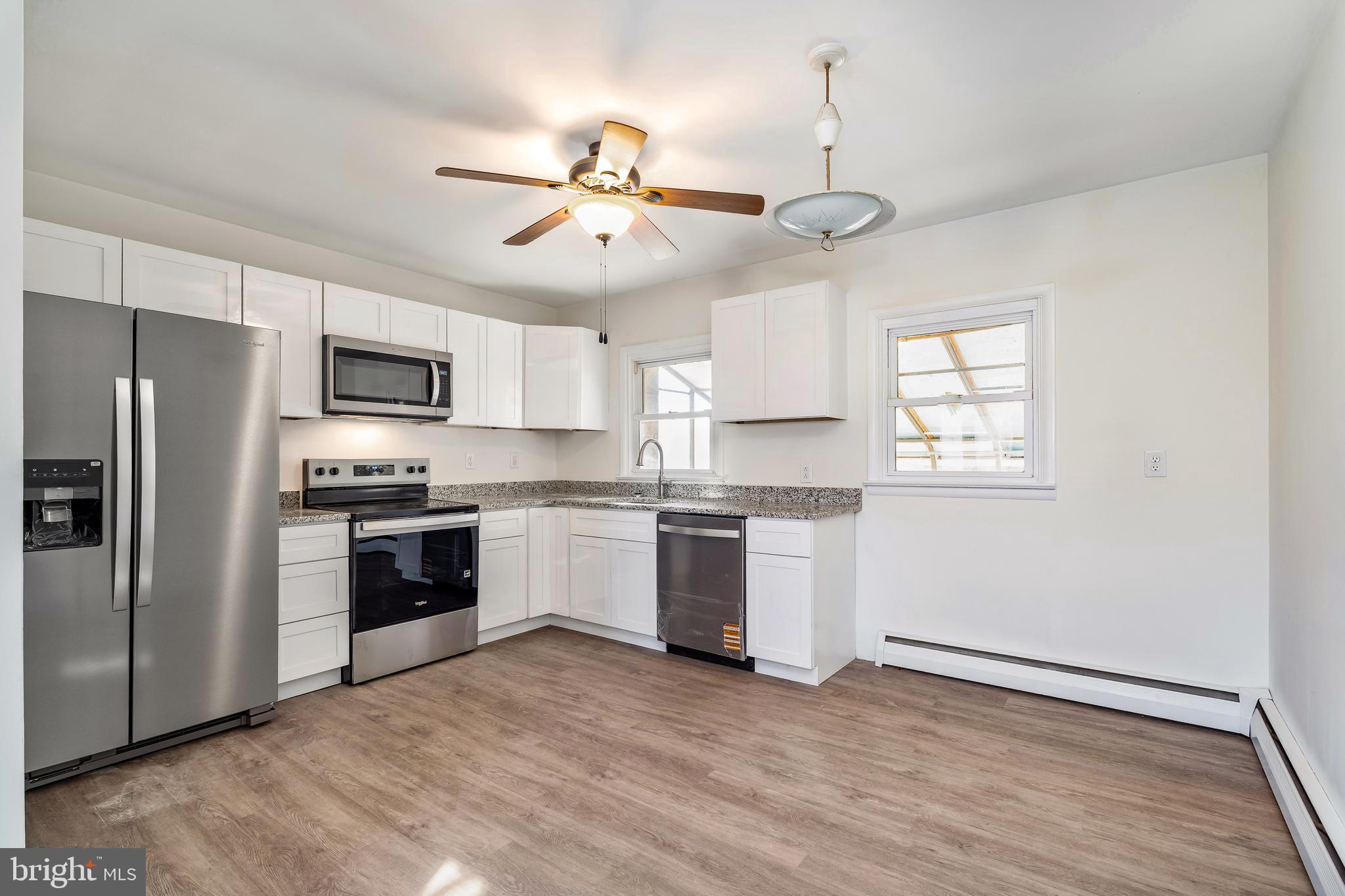 404 West Pearl Street Rising Sun, MD 21911 - Photo 7 of 23 a kitchen with a refrigerator and white cabinets