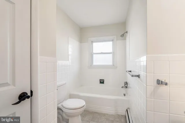 a white bath tub sitting next to a toilet