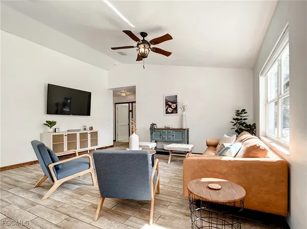 a living room with furniture and a flat screen tv