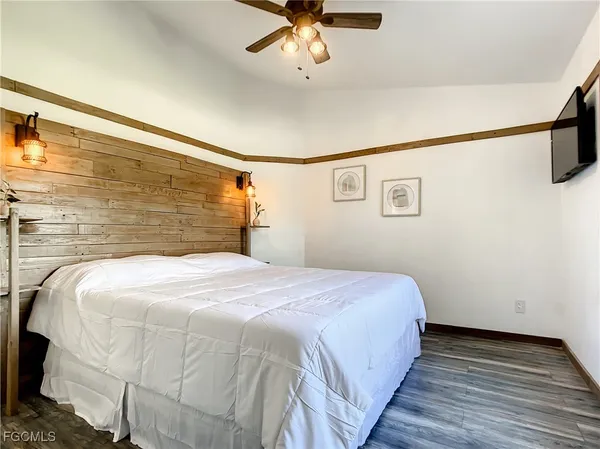 a bedroom with a bed and a ceiling fan
