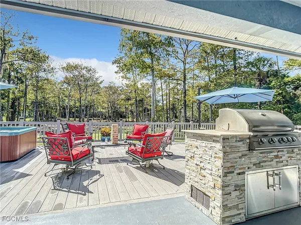 a outdoor sitting area with furniture and wooden floor