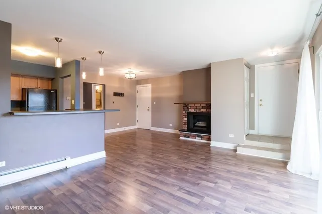 a view of a kitchen with a sink and a refrigerator