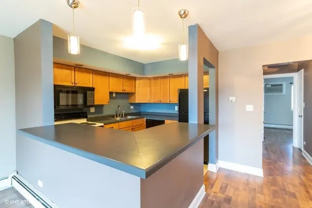 a view of a kitchen with kitchen island a large window
