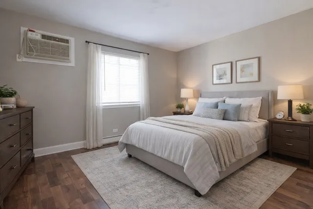 a spacious bedroom with a bed and a window