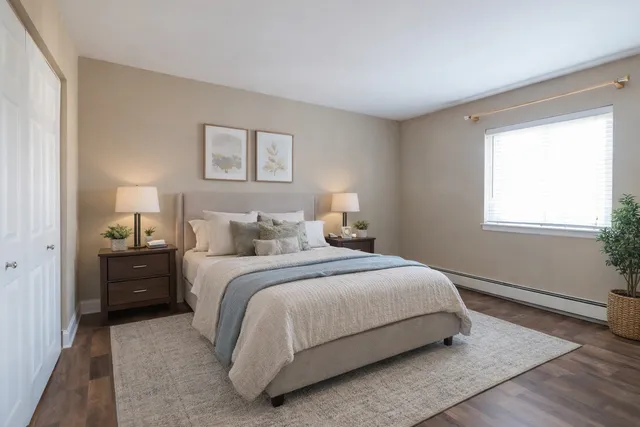 a bedroom with a bed and a window