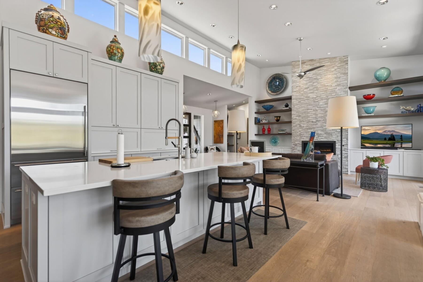 61487 Hackleman Court Bend, OR 97702 - Photo 8 of 35 a kitchen with stainless steel appliances kitchen island granite countertop a table chairs in it and a window