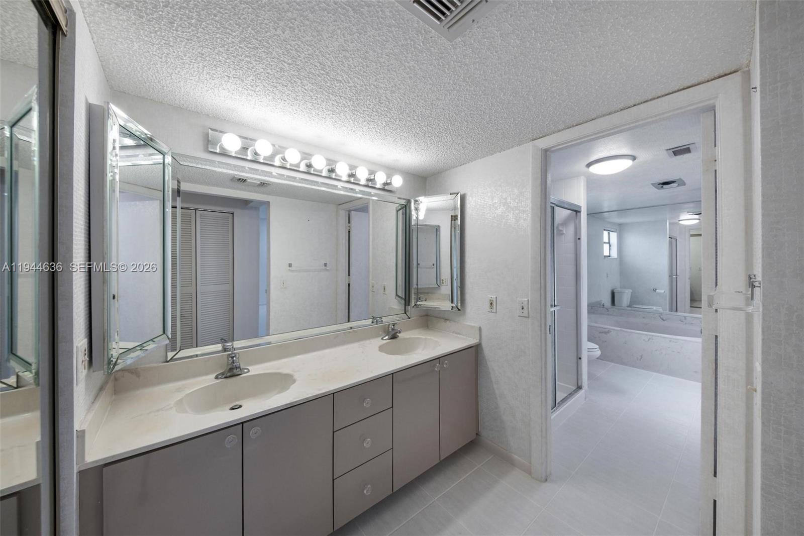 21877 Arriba Real Boca Raton, FL 33433 - Photo 11 of 40 a spacious bathroom with a double vanity sink mirror and shower