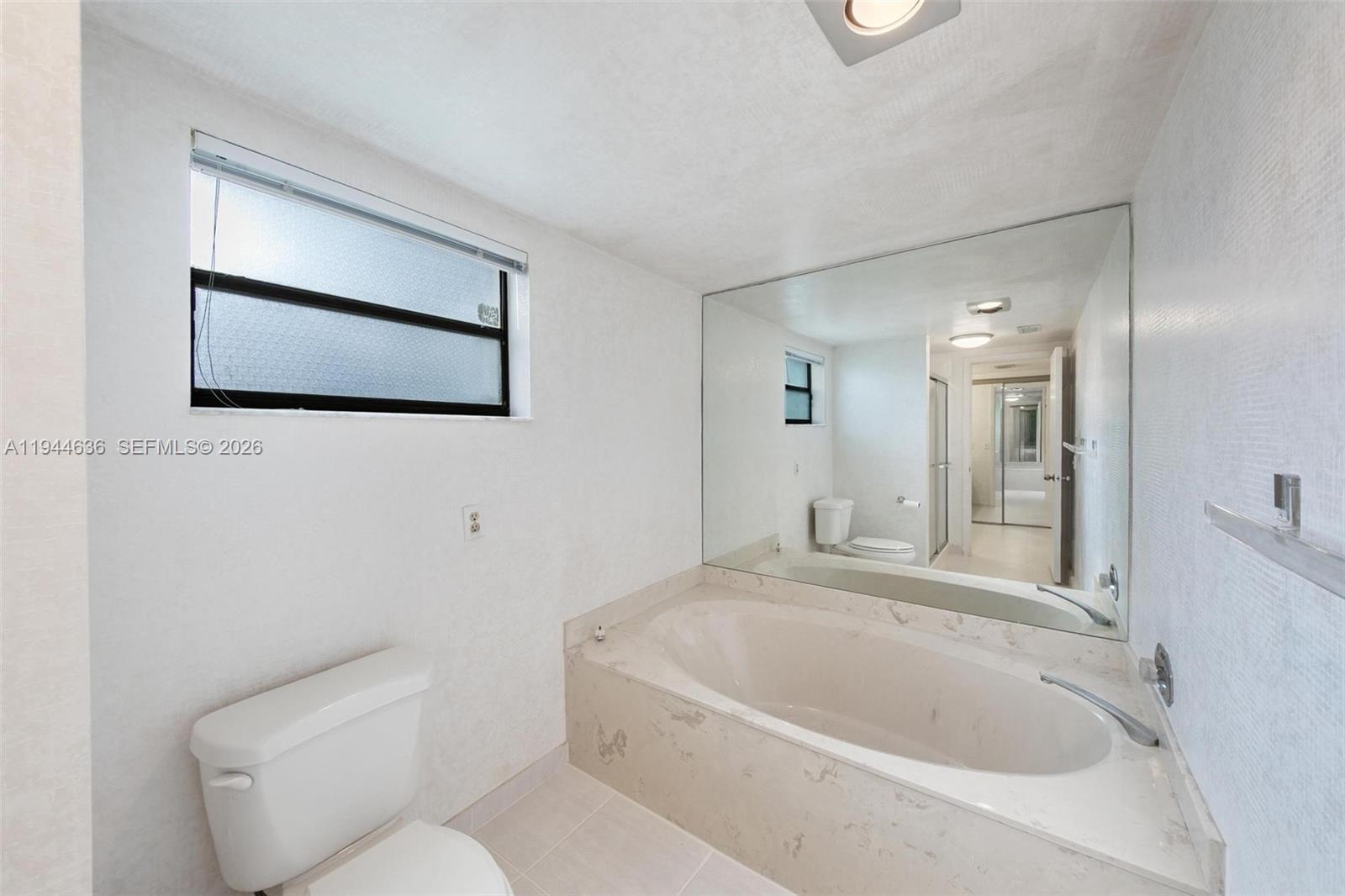 21877 Arriba Real Boca Raton, FL 33433 - Photo 12 of 40 a bathroom with a toilet sink and mirror