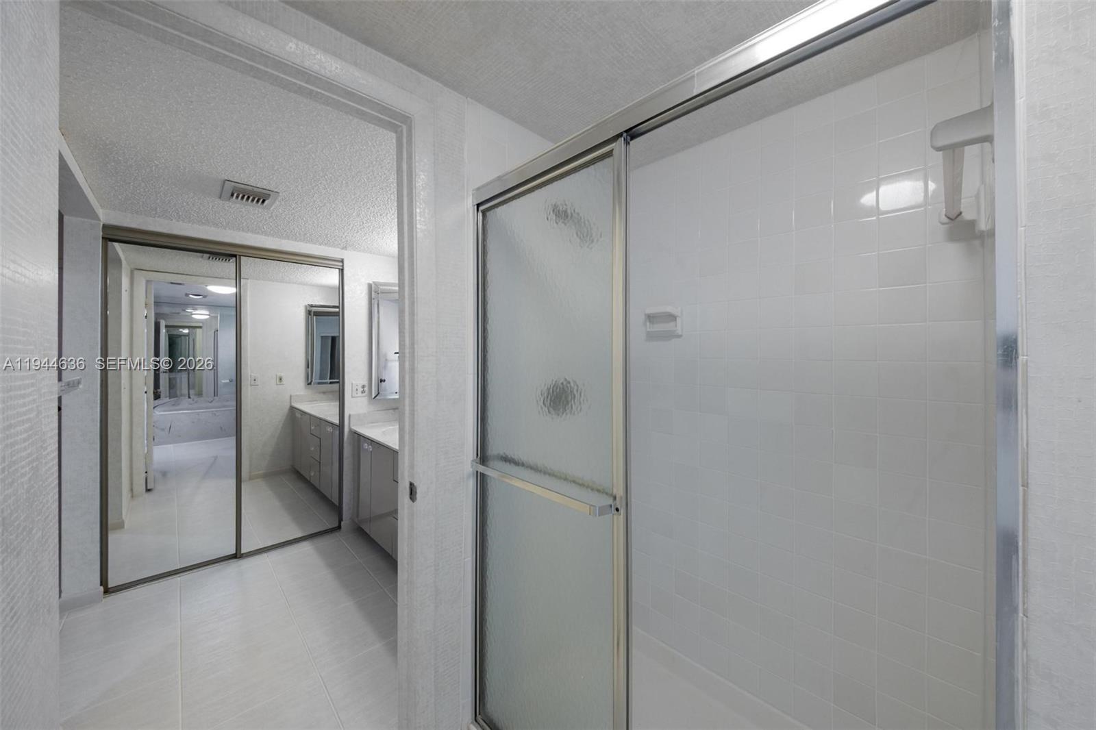 21877 Arriba Real Boca Raton, FL 33433 - Photo 13 of 40 a bathroom with a glass shower door