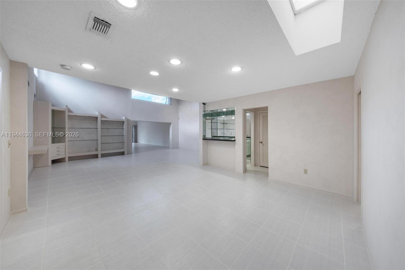 21877 Arriba Real Boca Raton, FL 33433 - Photo 22 of 40 an empty room with a cabinet and mirrors