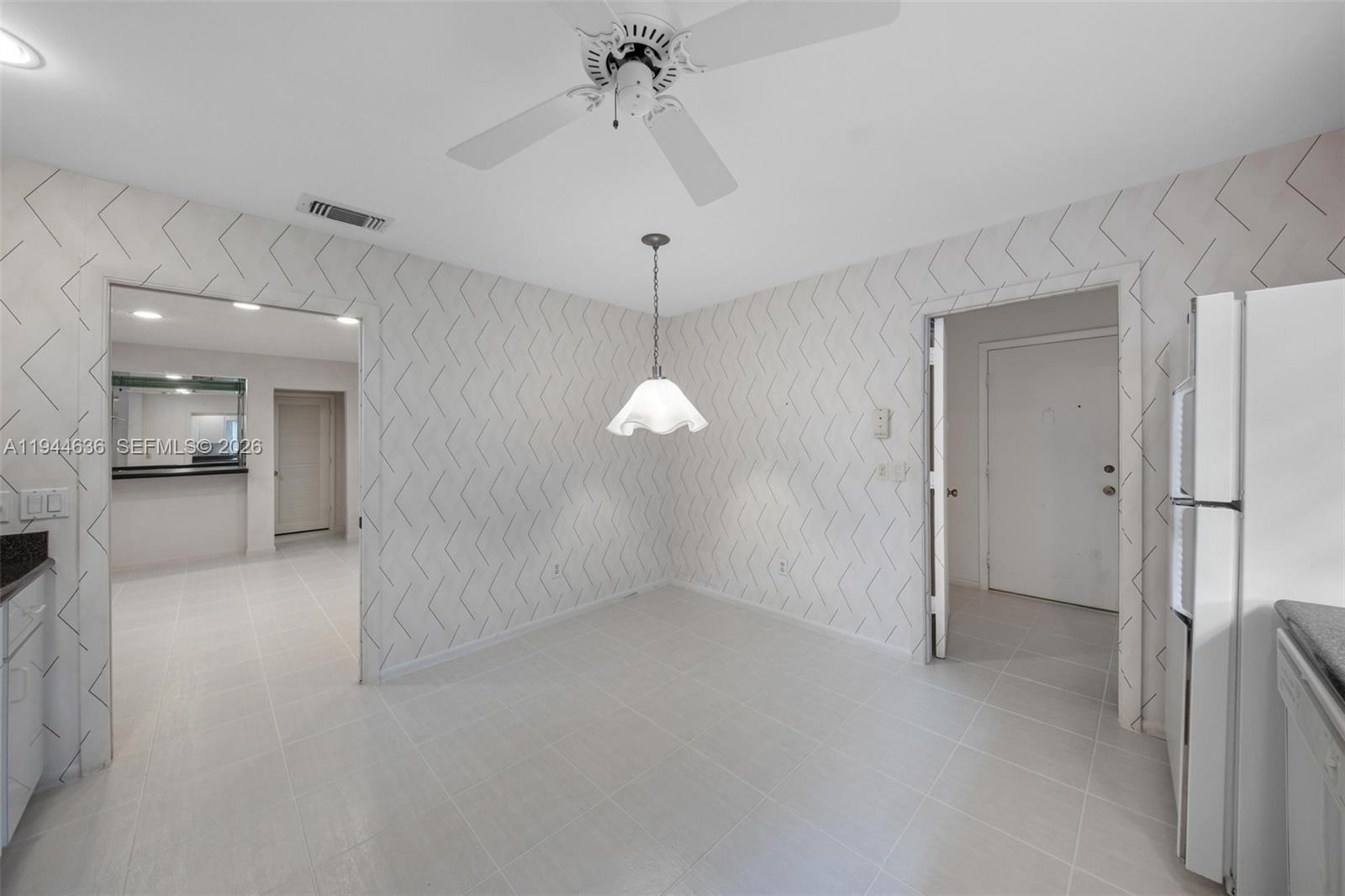 21877 Arriba Real Boca Raton, FL 33433 - Photo 26 of 40 a view of a room with an empty space and a kitchen