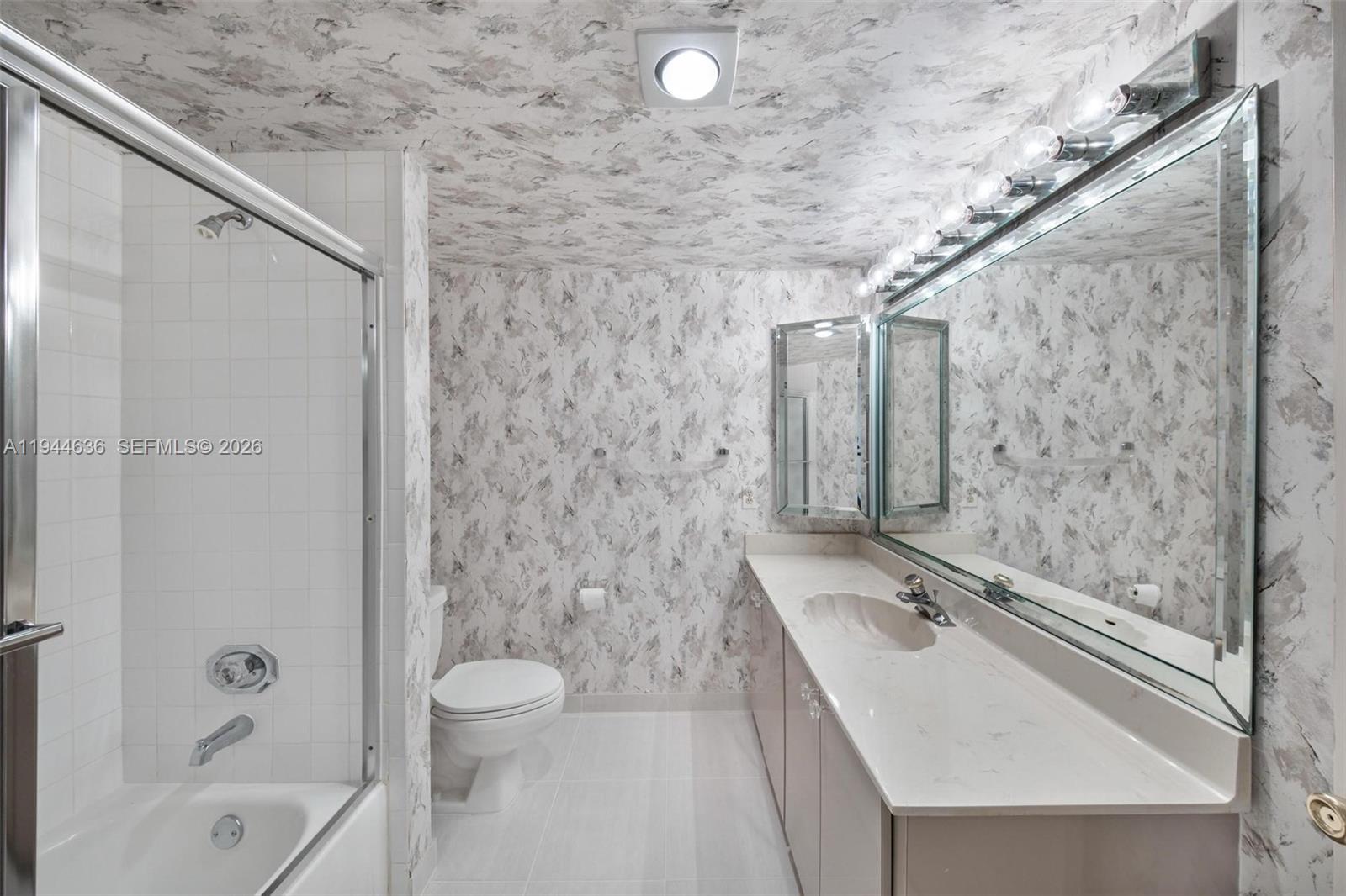 21877 Arriba Real Boca Raton, FL 33433 - Photo 32 of 40 a bathroom with a granite countertop sink a toilet and shower