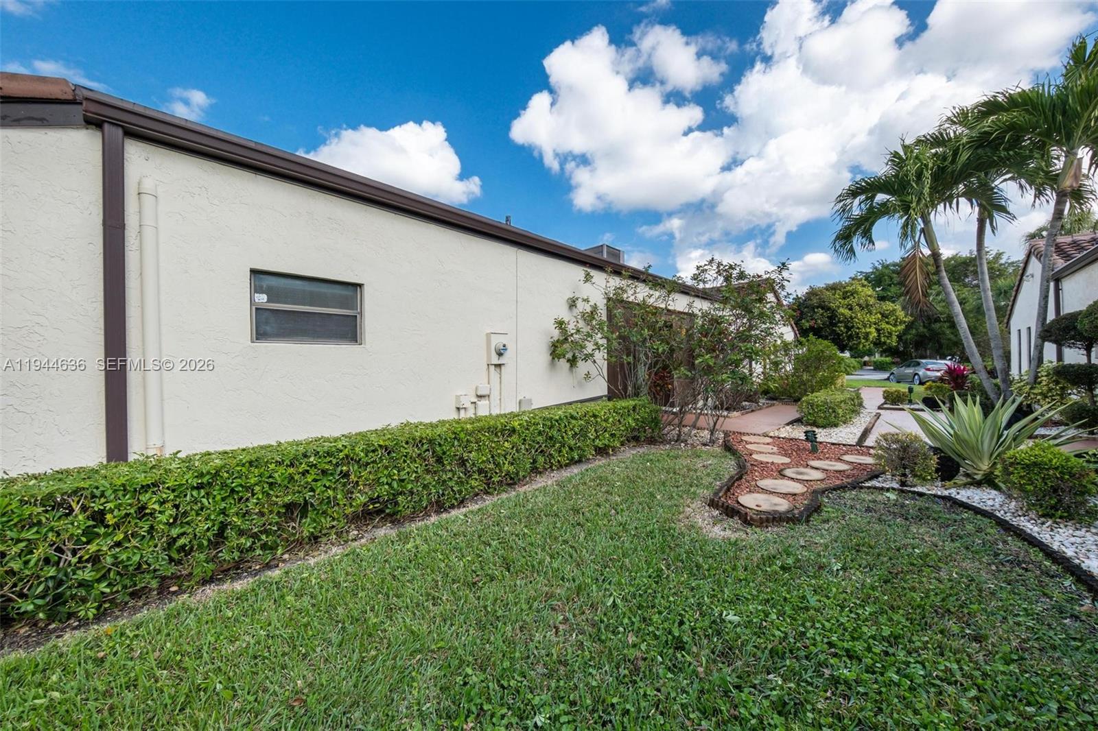 21877 Arriba Real Boca Raton, FL 33433 - Photo 37 of 40 a front view of a house with garden
