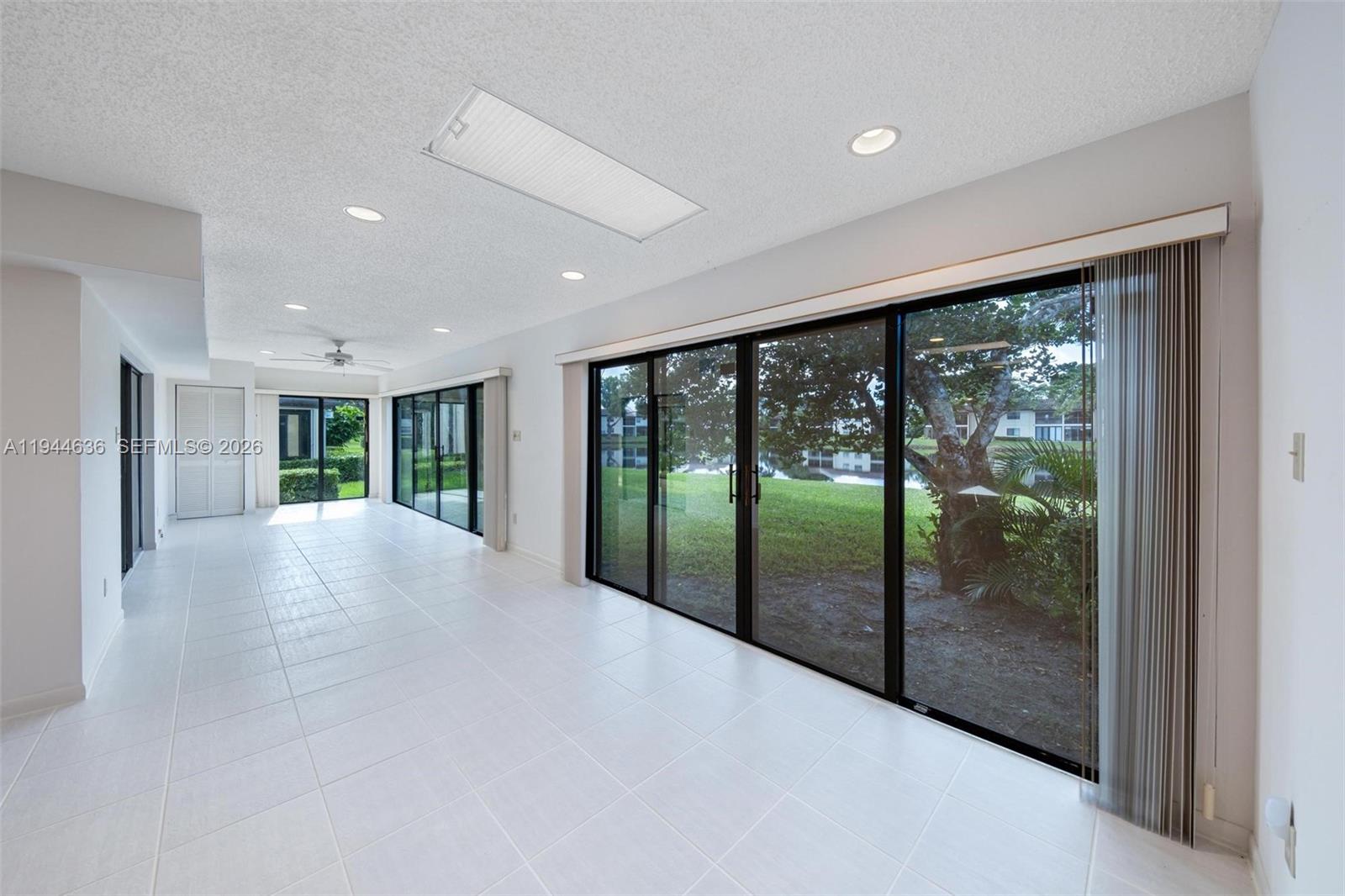 21877 Arriba Real Boca Raton, FL 33433 - Photo 5 of 40 a view of an empty room with wooden floor and a balcony