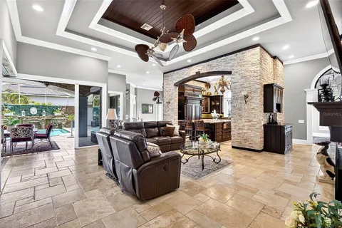 a kitchen with kitchen island granite countertop a stove and a wooden floors