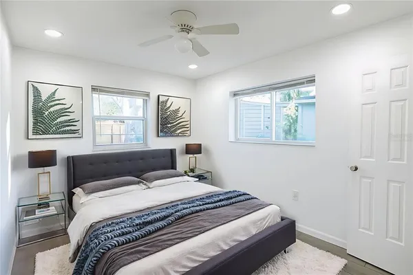 a bedroom with a large bed and a window
