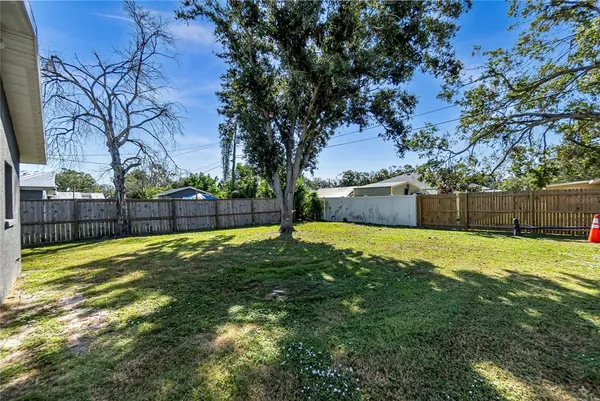 a view of yard with swimming pool and seating space