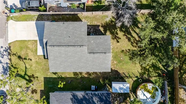 an aerial view of a house with a yard