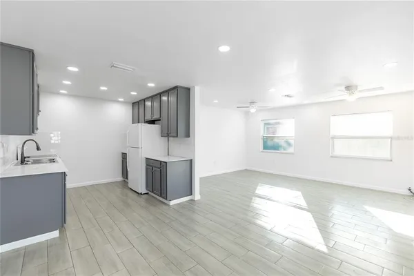 a view of a kitchen with a sink and wooden floor