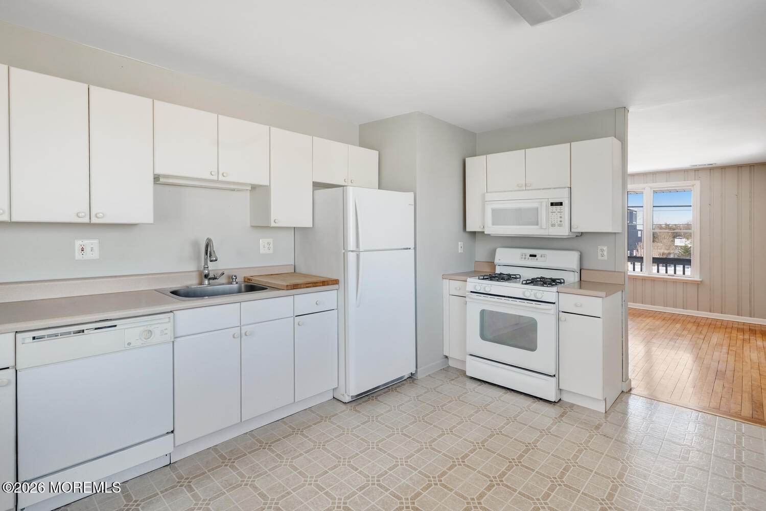 2402 R Central Avenue Barnegat Light, NJ 08006 - Photo 9 of 27 a kitchen with granite countertop white cabinets and white appliances