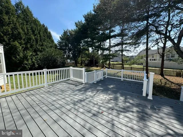 a view of balcony with wooden floor and fence