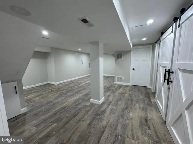 a kitchen with stainless steel appliances granite countertop a stove a sink dishwasher and a microwave oven with wooden floor