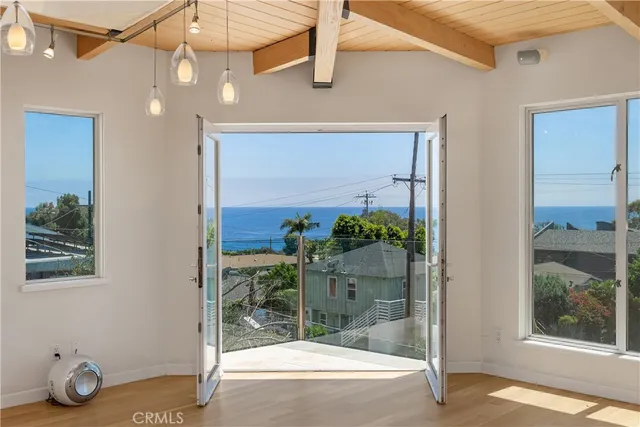 a view of a room with wooden floor and outdoor space