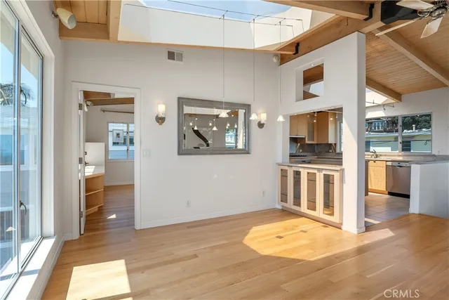 a large dining hall with stainless steel appliances granite countertop a sink and cabinets
