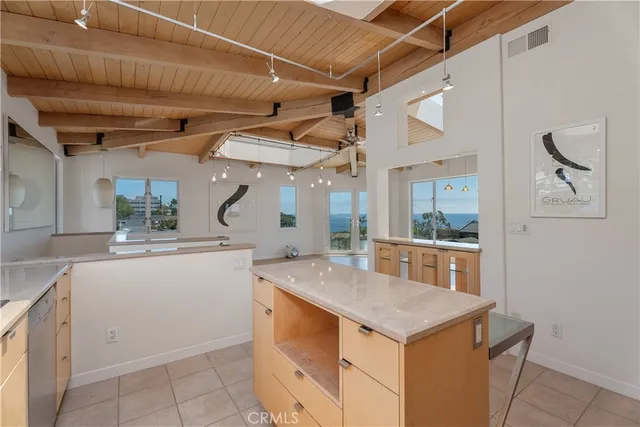 a kitchen with stainless steel appliances granite countertop a sink and dishwasher a refrigerator with white cabinets