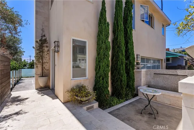a view of a hallway with wooden floor and a kitchen