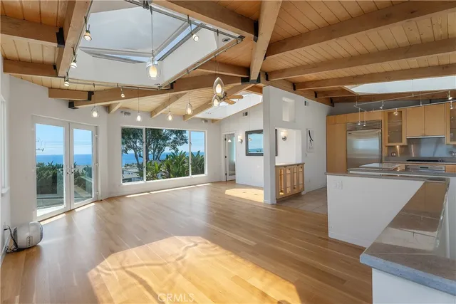a view of a room with wooden floor and windows