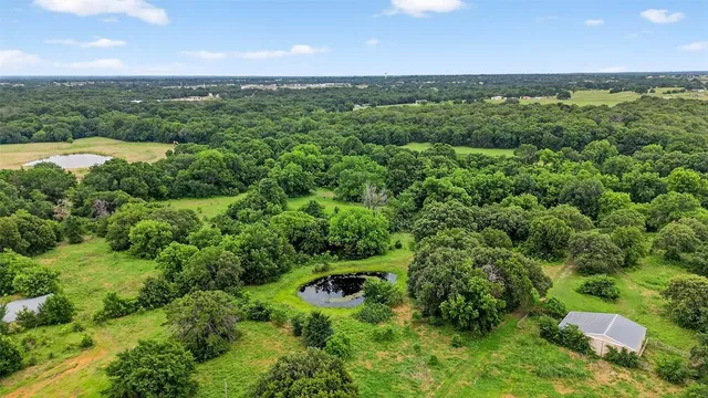 an aerial view of a houses with a yard