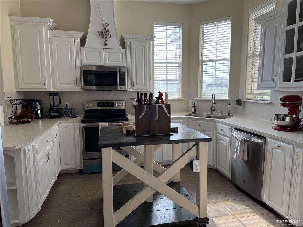 2600 Rhett Drive Pharr, TX 78577 - Photo 5 of 20 a kitchen with stainless steel appliances granite countertop a stove a sink and white cabinets