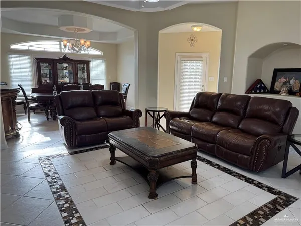 a living room with furniture and a chandelier