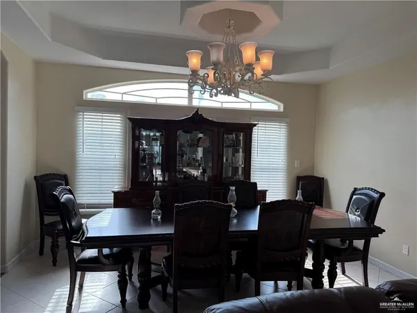 a view of a dining room with furniture and chandelier