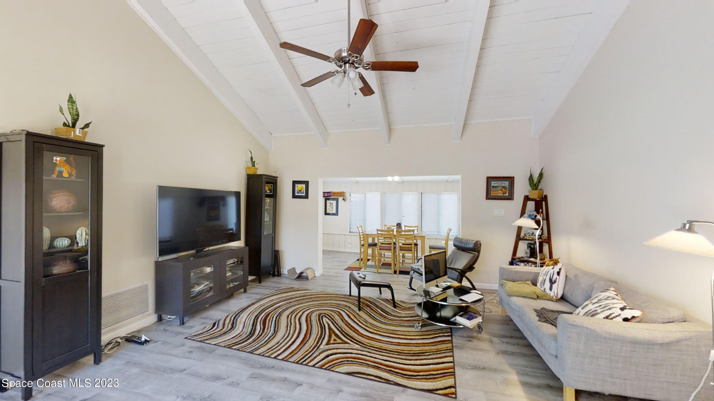295 Bayhead Drive Melbourne, FL 32940 - Photo 13 of 19 a living room with furniture and a flat screen tv